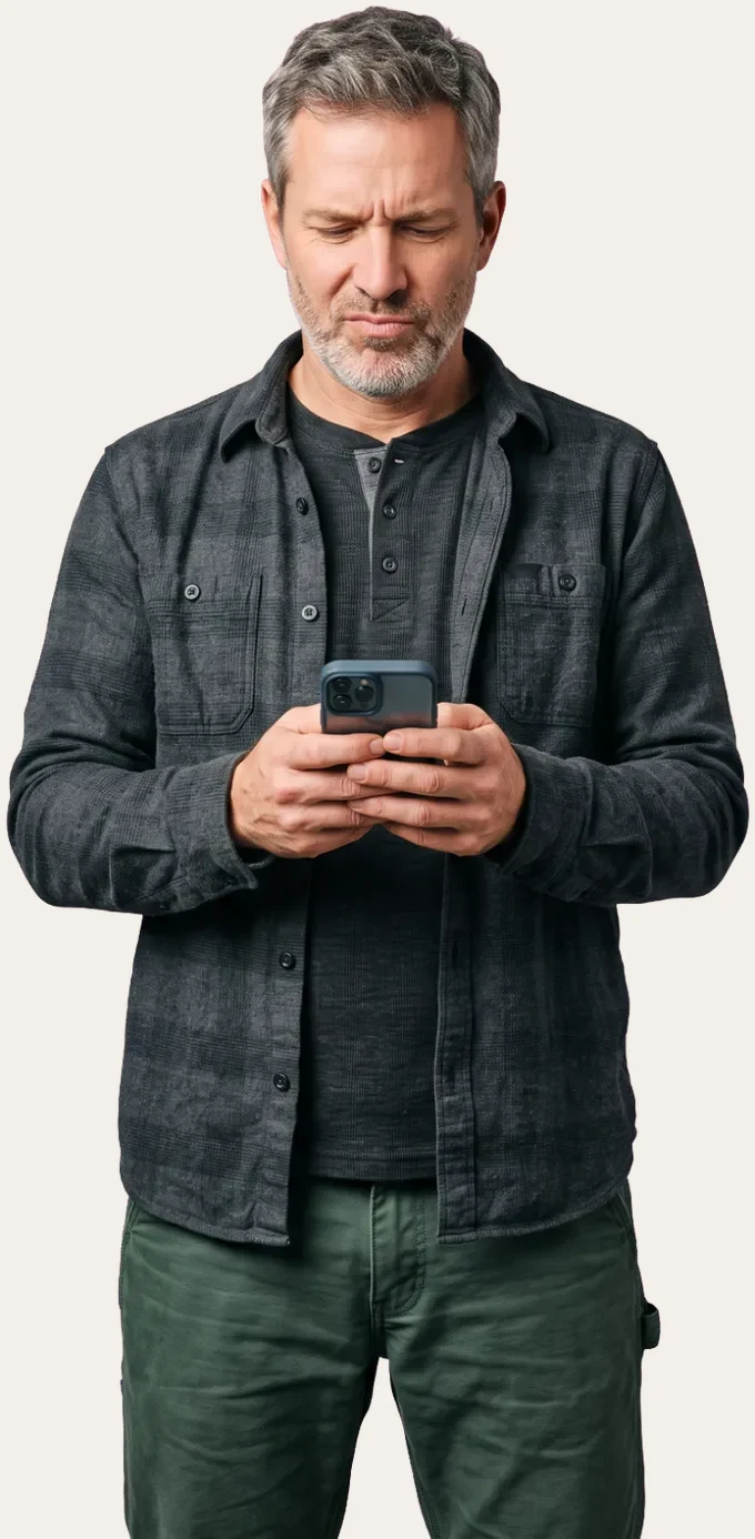 Shopper looking at his phone, frustrated by a search that returned nothing