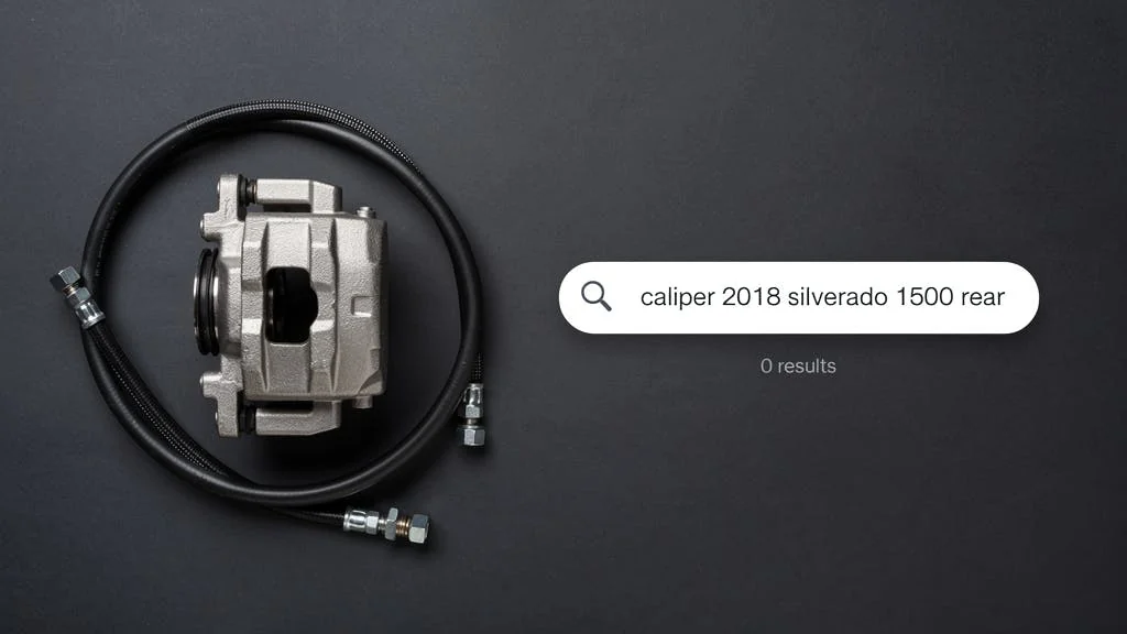 Brake caliper beside a storefront search bar showing "caliper 2018 silverado 1500 rear" and zero results
